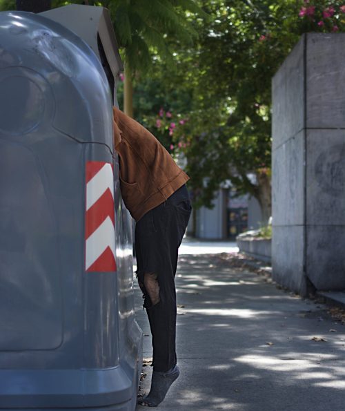 beggar-looking-through-trash-bins-streets